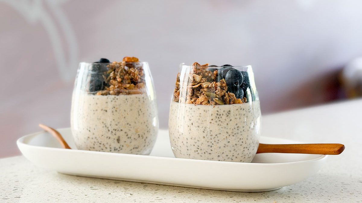 Maca Protein Overnight Chia Oats on kitchen bench with pouch of maca powder