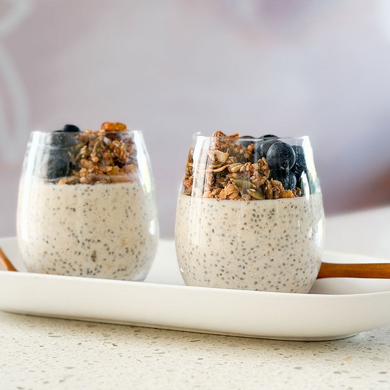 Maca Protein Overnight Chia Oats on kitchen bench with pouch of maca powder