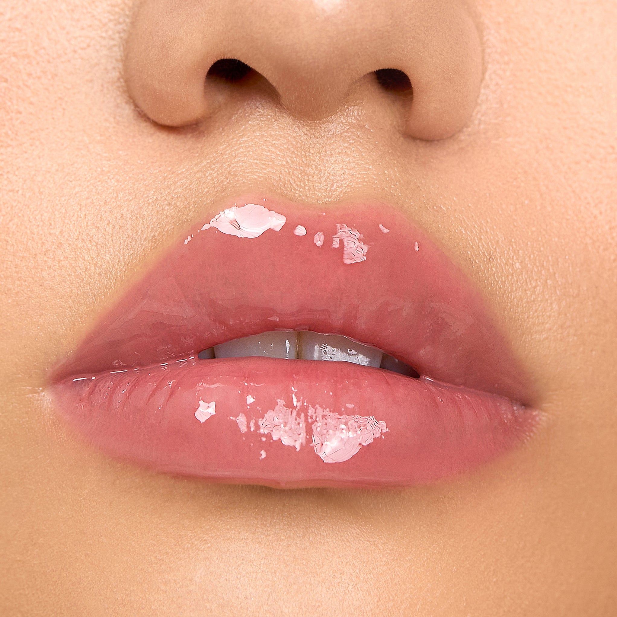 Close-up of model wearing Aleph Aura Gloss: Bare