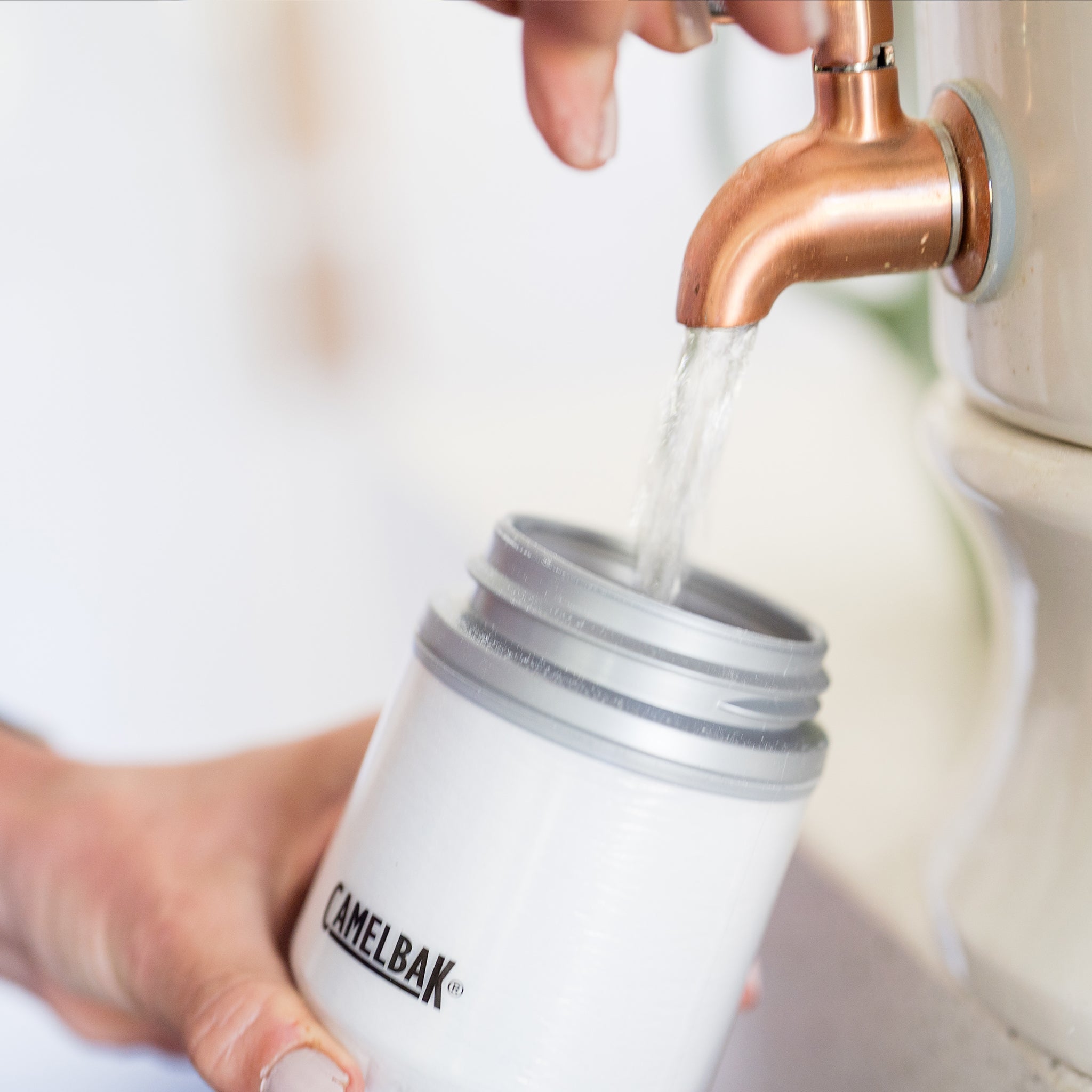 Amy adding water to a bottle of Daily Hydration Blend