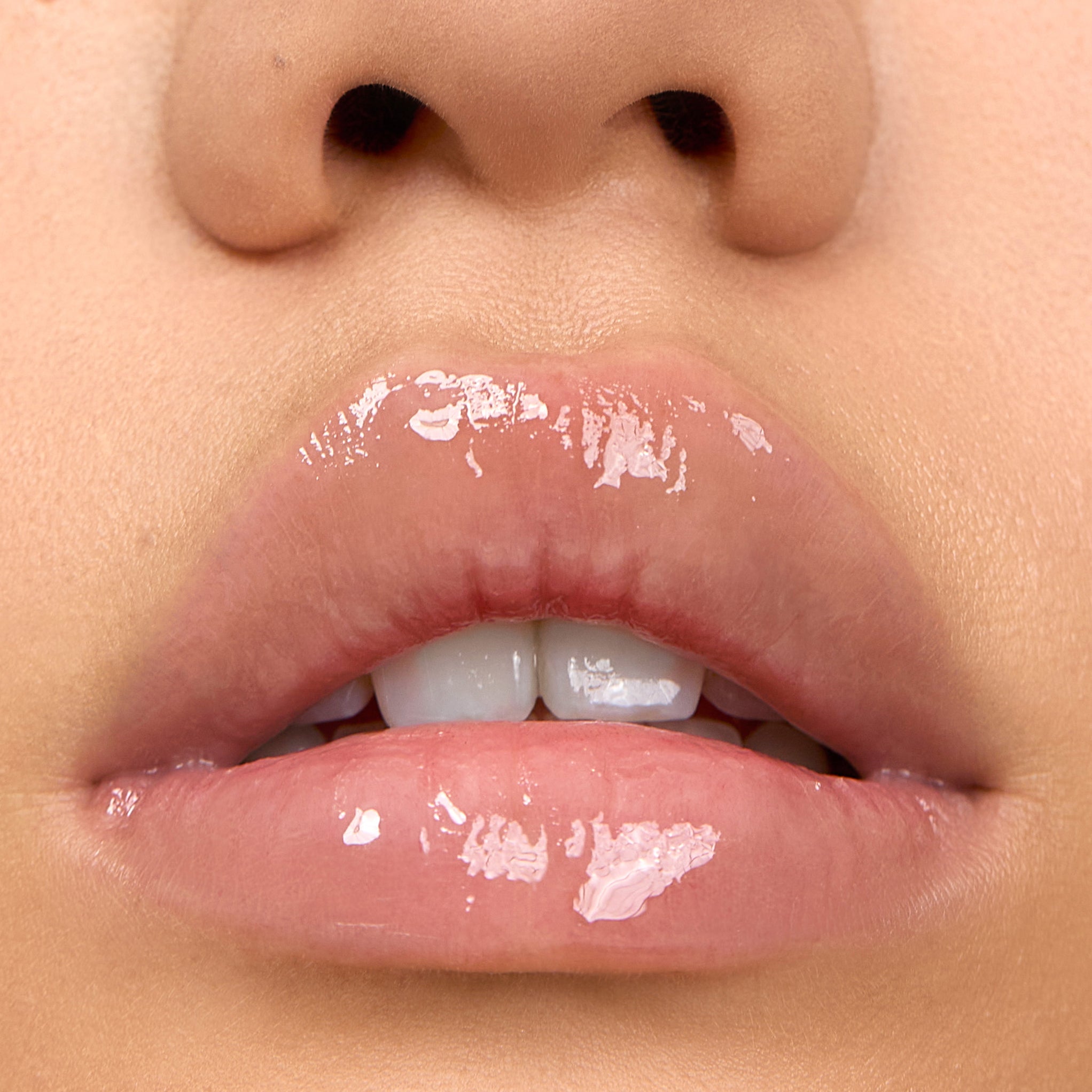 Close-up of model wearing Aleph Aura Gloss: Lumen