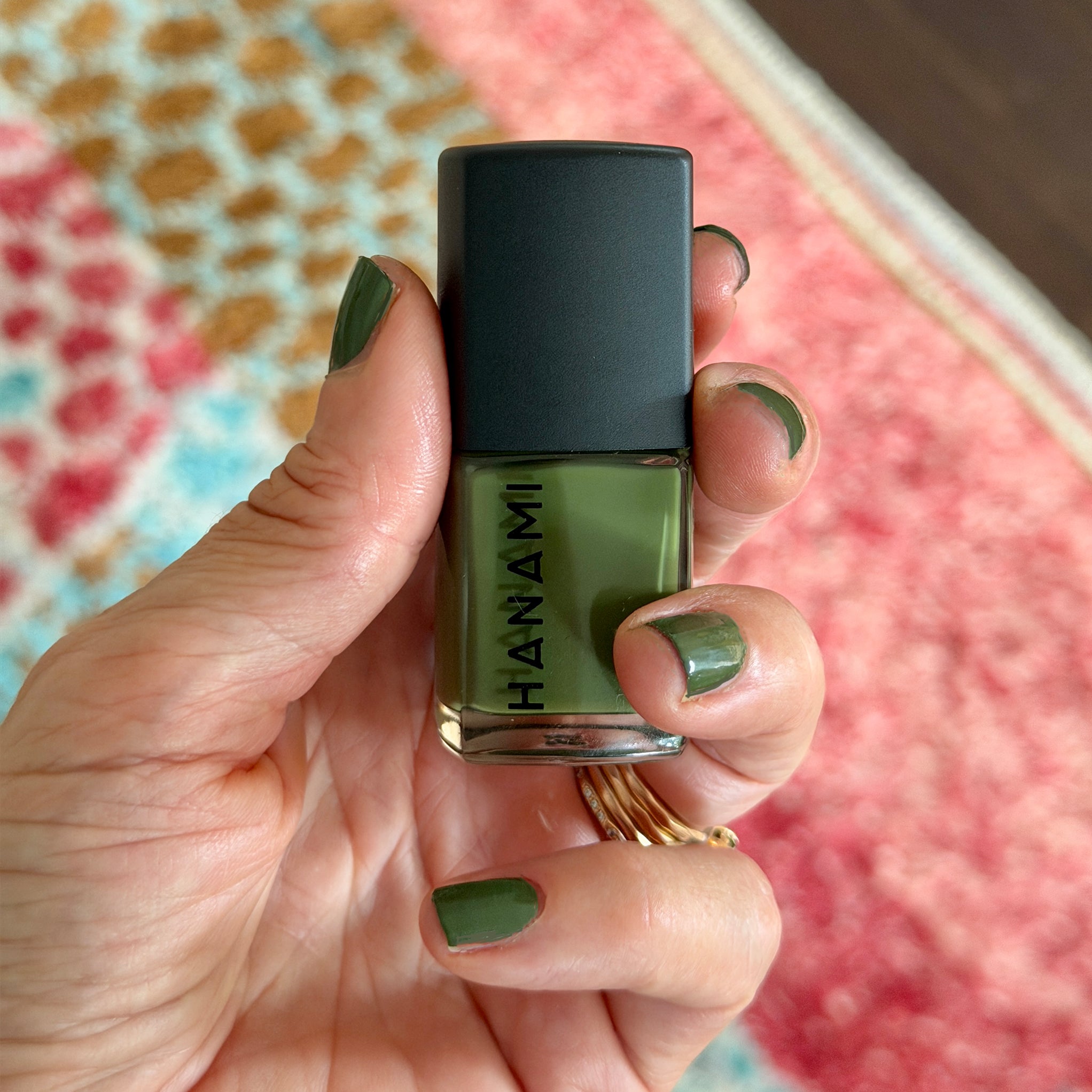 Amy holding a bottle of Hanami 'The Moss' nail polish