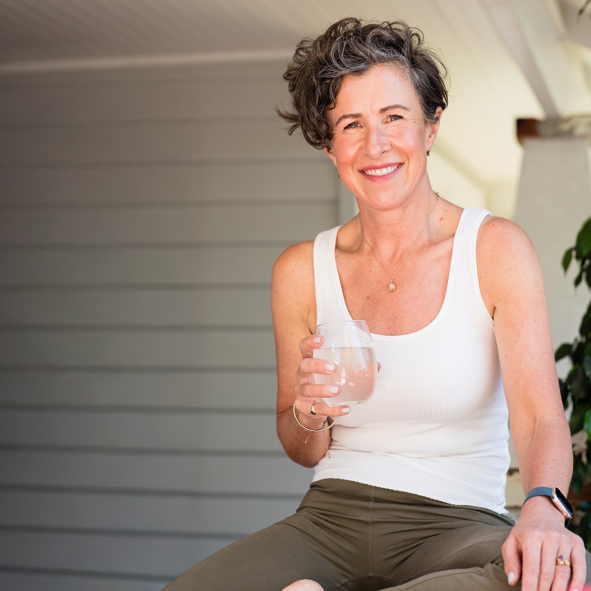 Amy holding a glass of Marine Collagen