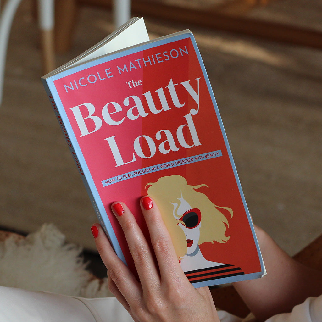 Amy holding a copy of The Beauty Load