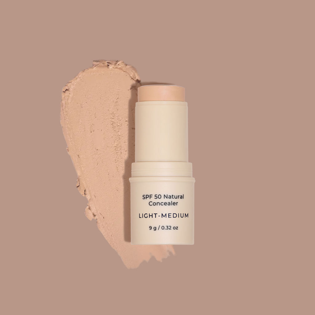 SPF 50 Natural Concealer stick with a swatch on a beige background