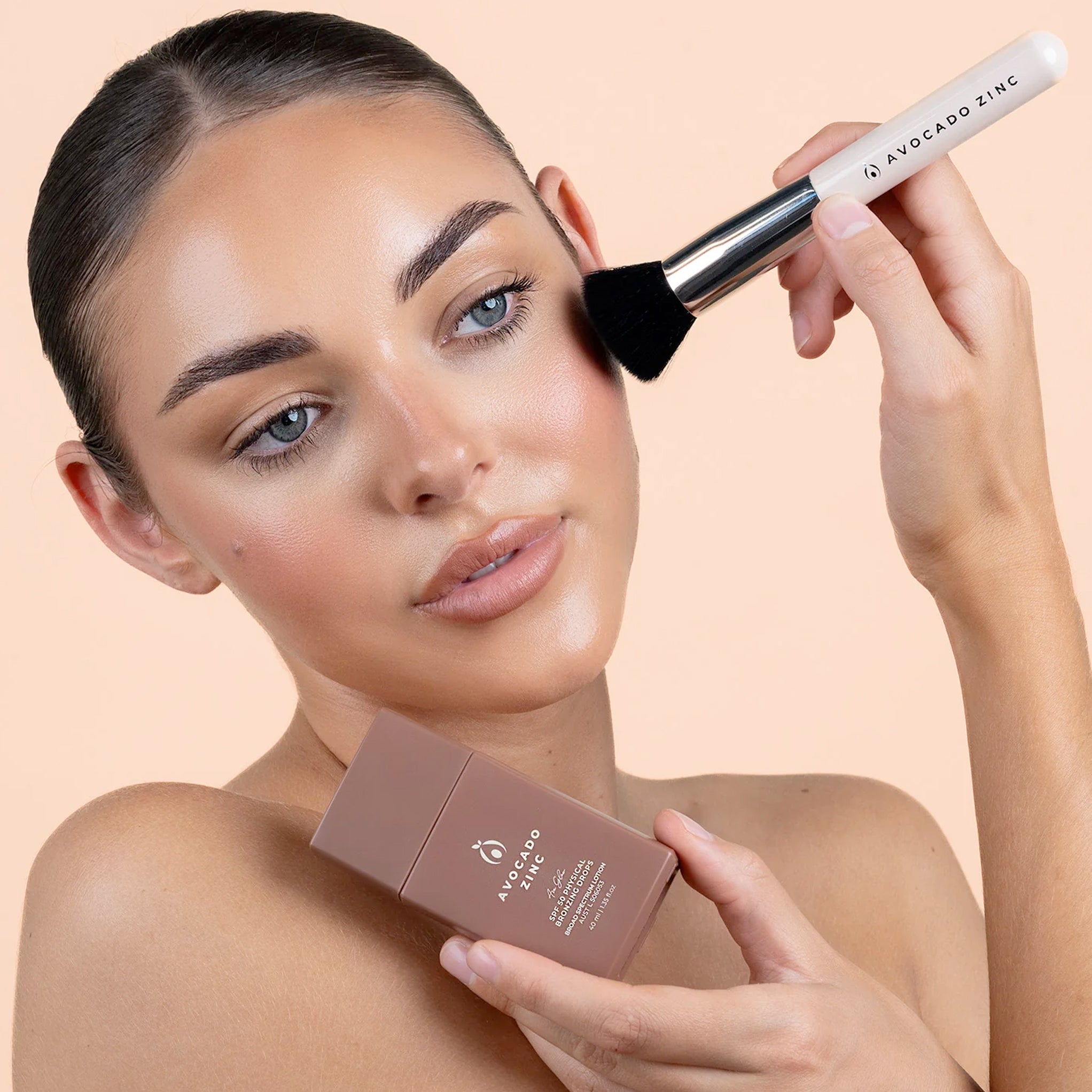 Model wearing Avocado Zinc SPF 50 Physical Bronzing Drops