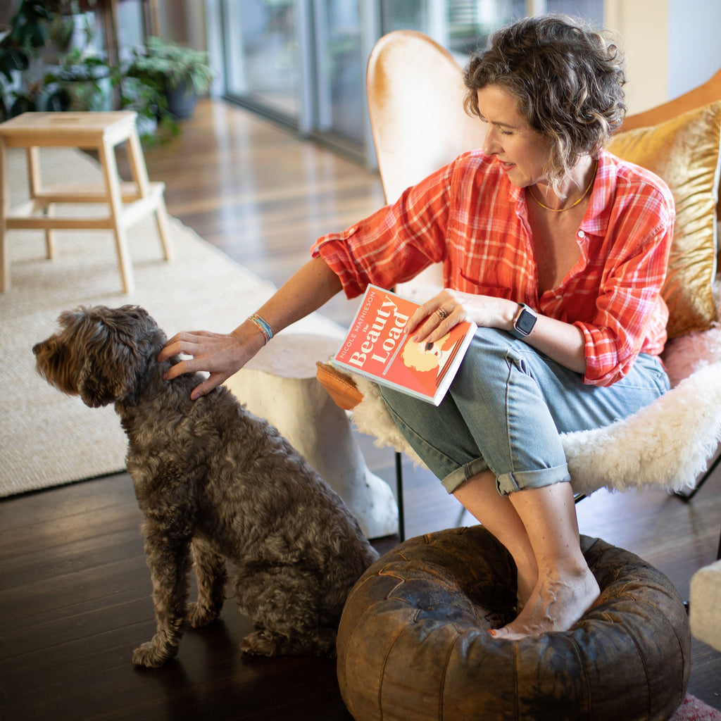 Amy reading The Beauty Load by Nicole Mathieson to Wilson