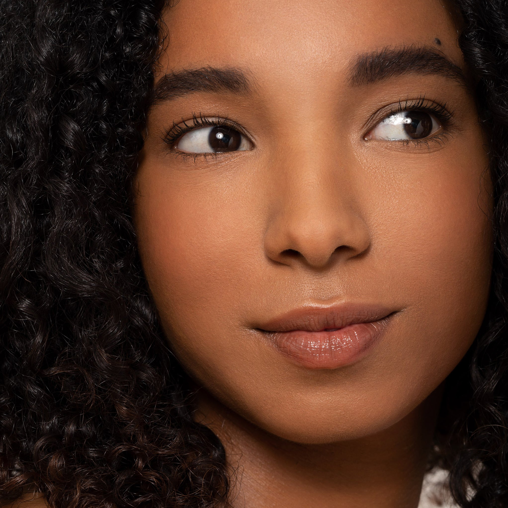 Model wearing Aleph Concealer /  Foundation  6.0 Neutral Dark