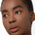 Model wearing Aleph Concealer /  Foundation  7.5 Neutral/Red Dark