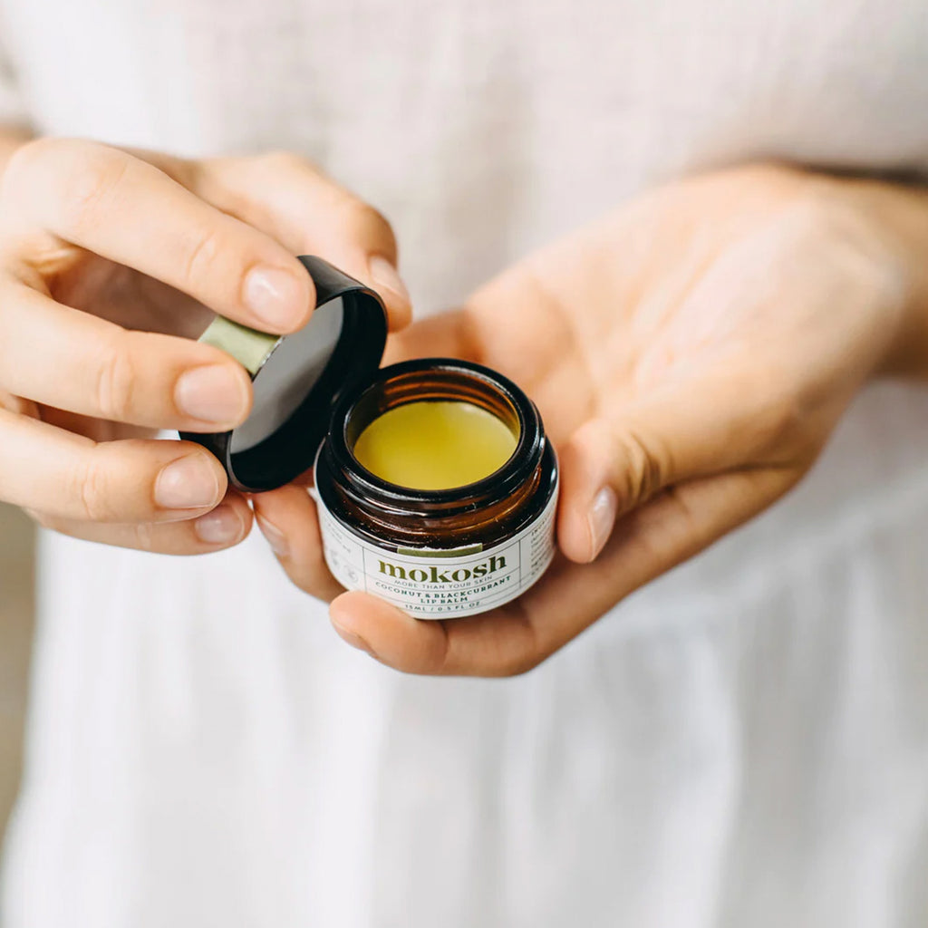 An open jar of Mokosh coconut and blackcurrant lip balm