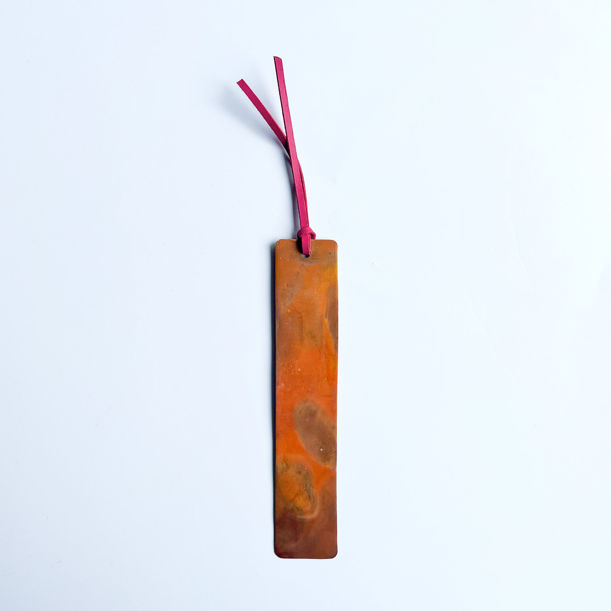 Copper bookmark with bright pink leather tassel