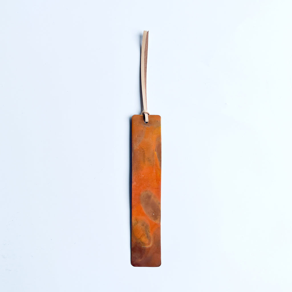 Copper bookmark with cream leather tassel. 