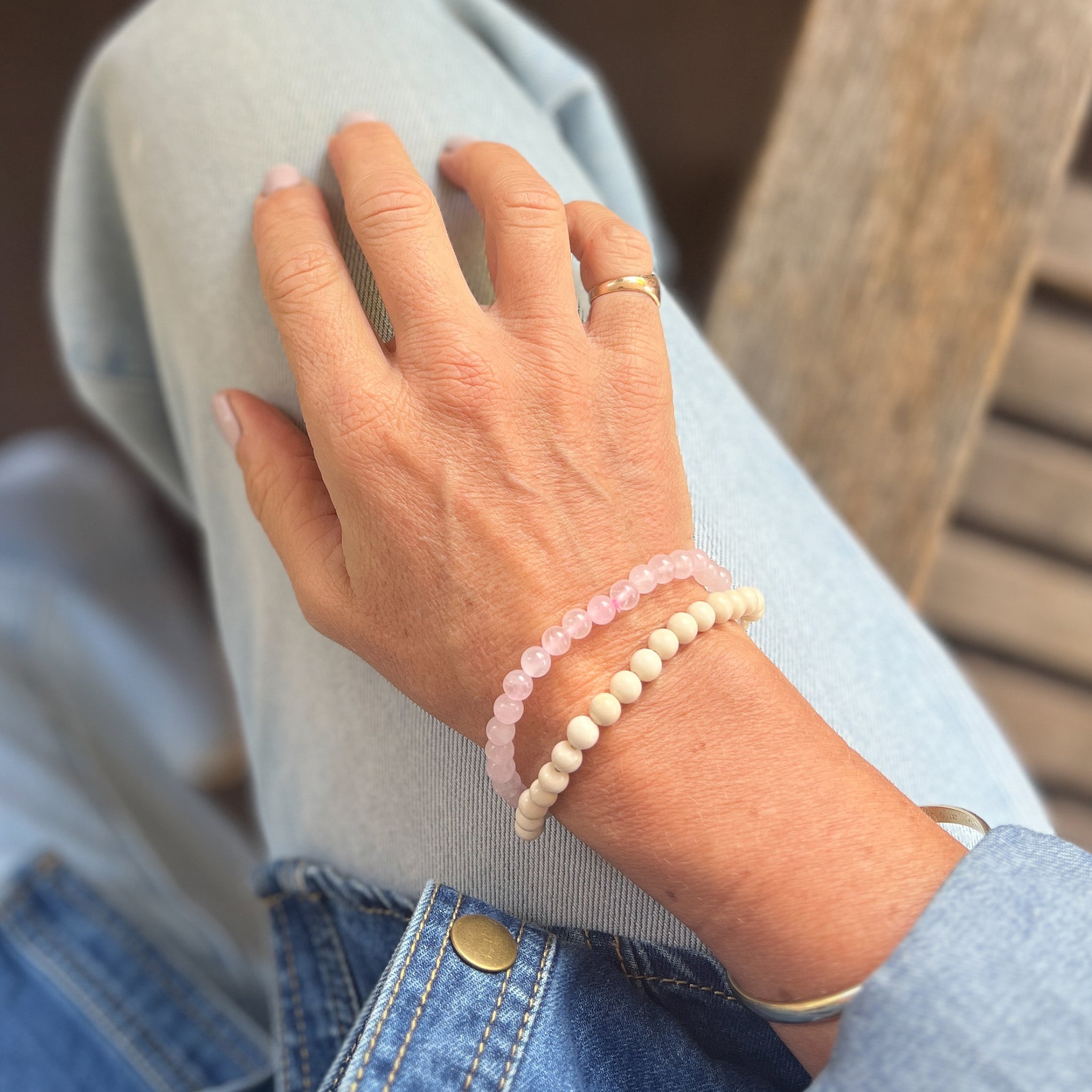 Amy wearing crystal bracelets in Rose Quartz and River Stone.