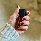 Woman's hand holding nail polish