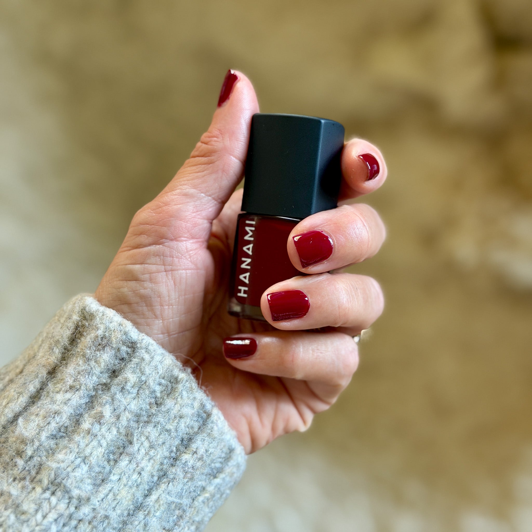Woman's hand holding nail polish