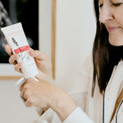 Woman using Clémence Organics Ultimate Hand & Body Lotion