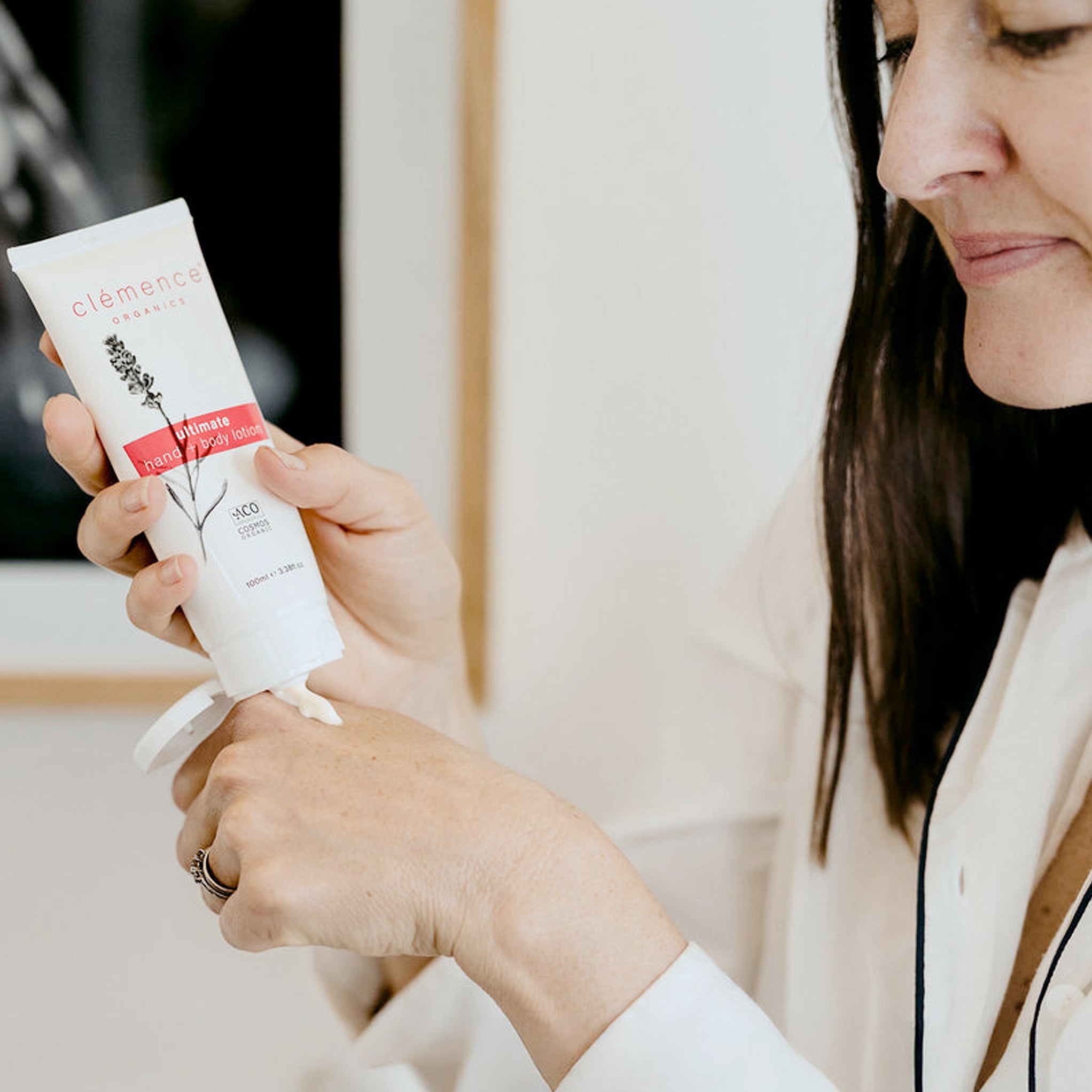 Woman using Clémence Organics Ultimate Hand & Body Lotion