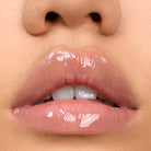 Close-up of model wearing Aleph Aura Gloss: Lumen