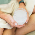 Amy holding a glass of Marine Collagen with Hyaluronic Acid