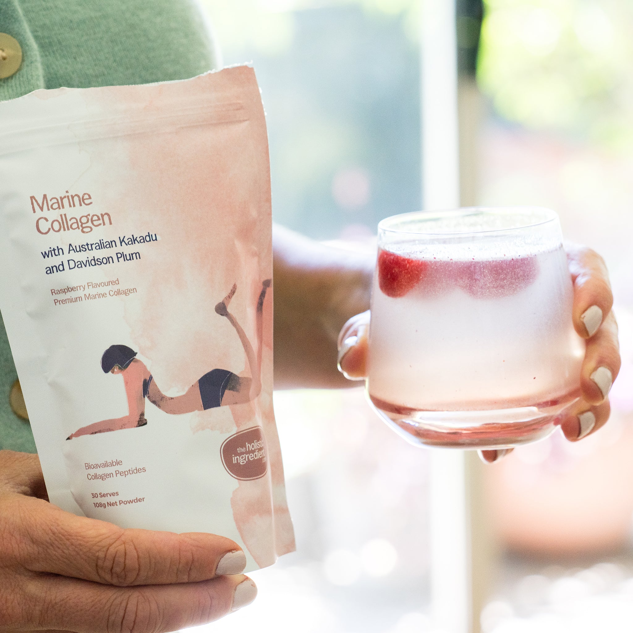 Amy holding a glass of Marine Collagen with Australian Kakadu and Davidson Plum