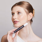 Model holding Aleph Lift/Lengthen Mascara