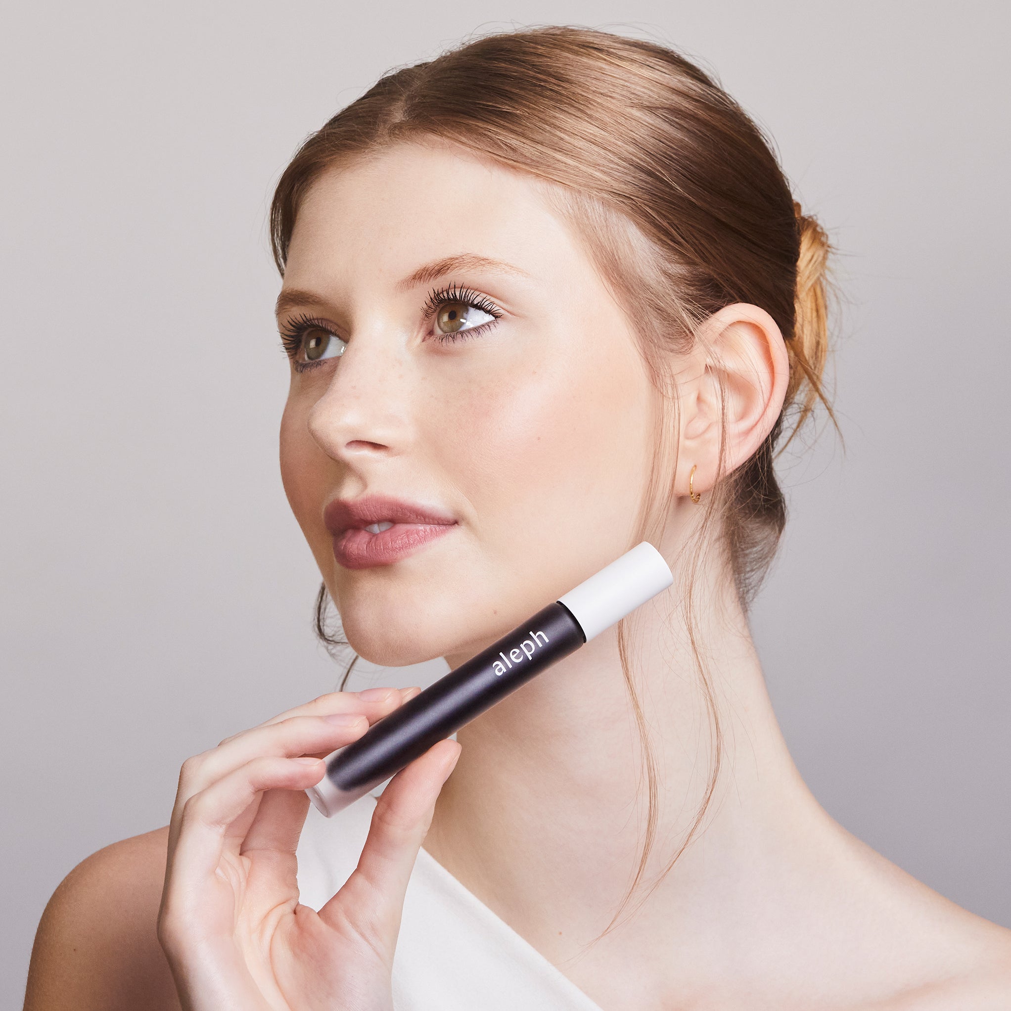 Model holding Aleph Lift/Lengthen Mascara