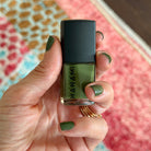 Amy holding a bottle of Hanami 'The Moss' nail polish 