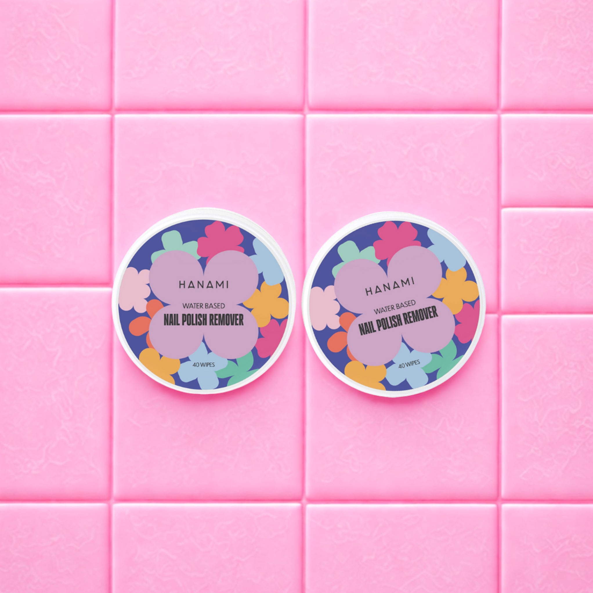 Two Hanami nail polish remover wipes on a pink tiled background
