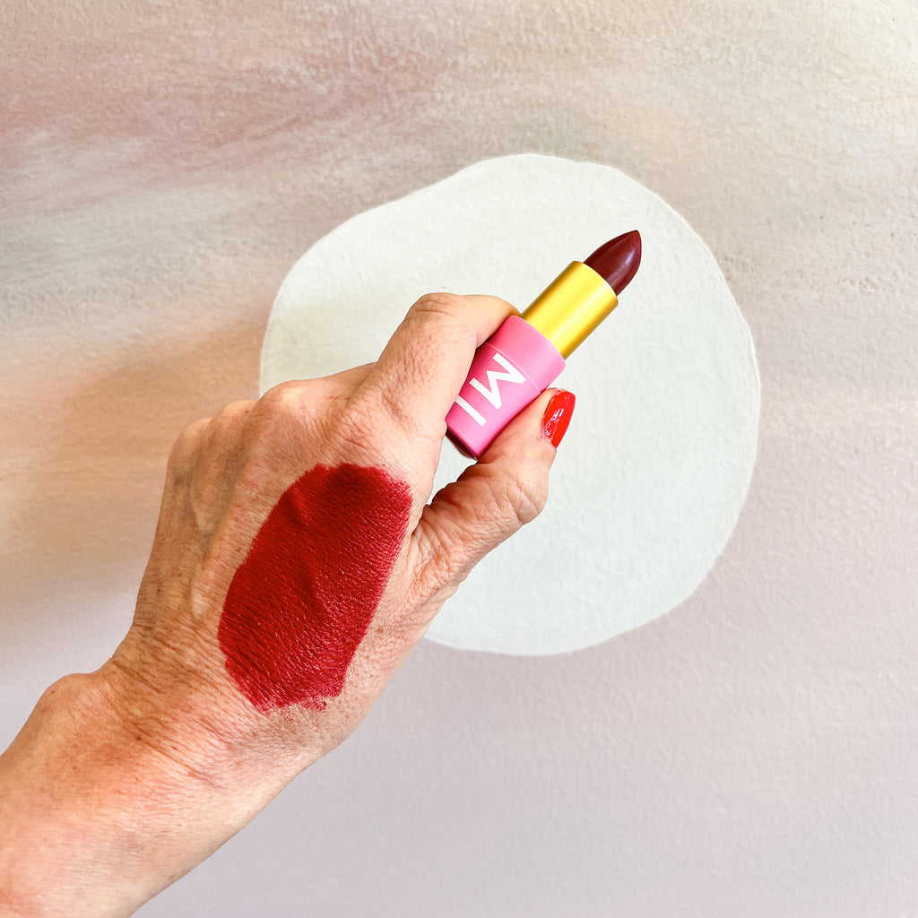 Amy testing Hanami Scarlet Letter lipstick on the back of her hand. 