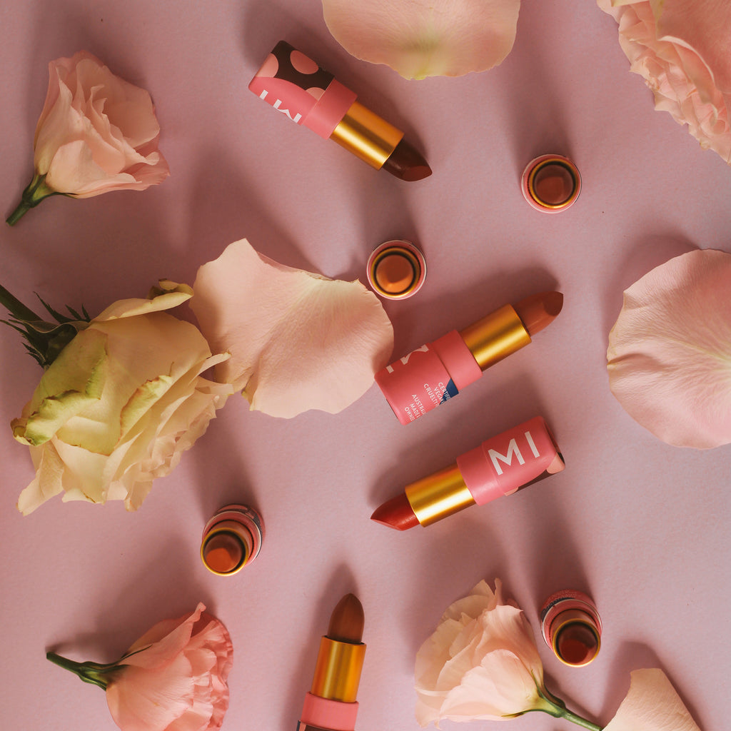A selection of Hanami lipsticks surrounded by rose petals. 