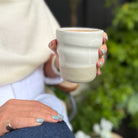 Amy holding a Sonos Studio Ceramic Cup
 in Snow