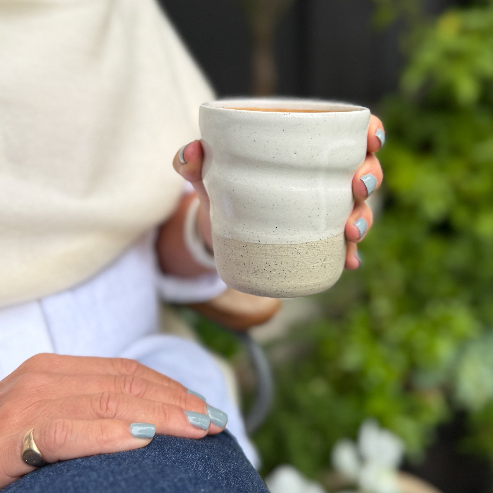 Amy holding a Sonos Studio Ceramic Cup
 in Snow