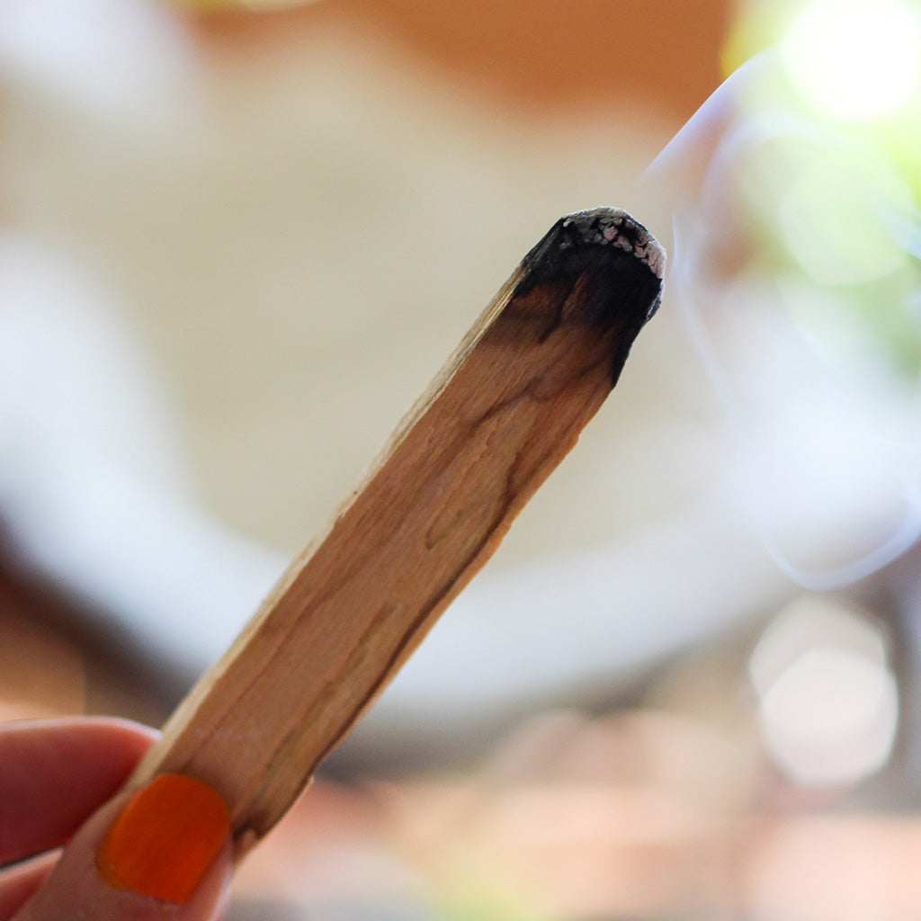 Clearing away negative energy with palo santo.