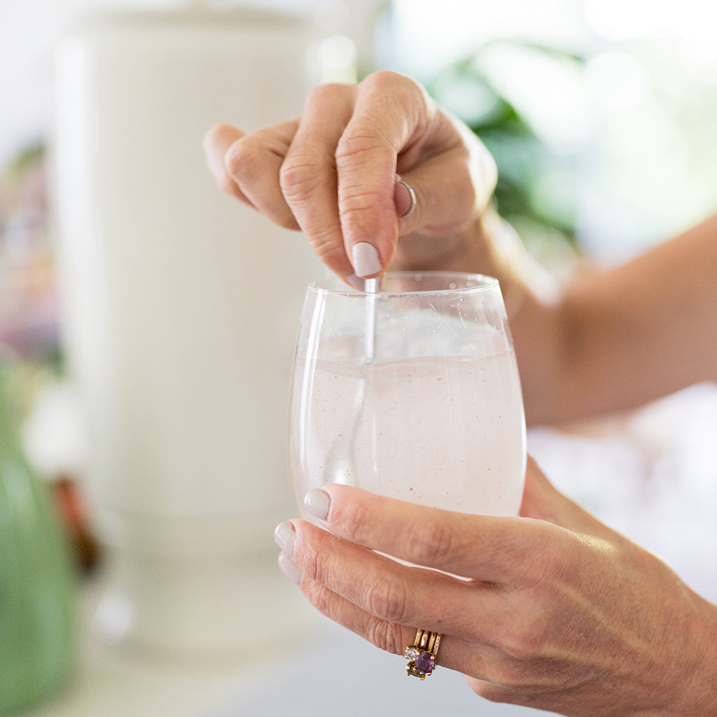 Amy holding a glass of Marine Collagen with Kakadu and Davidson Plum