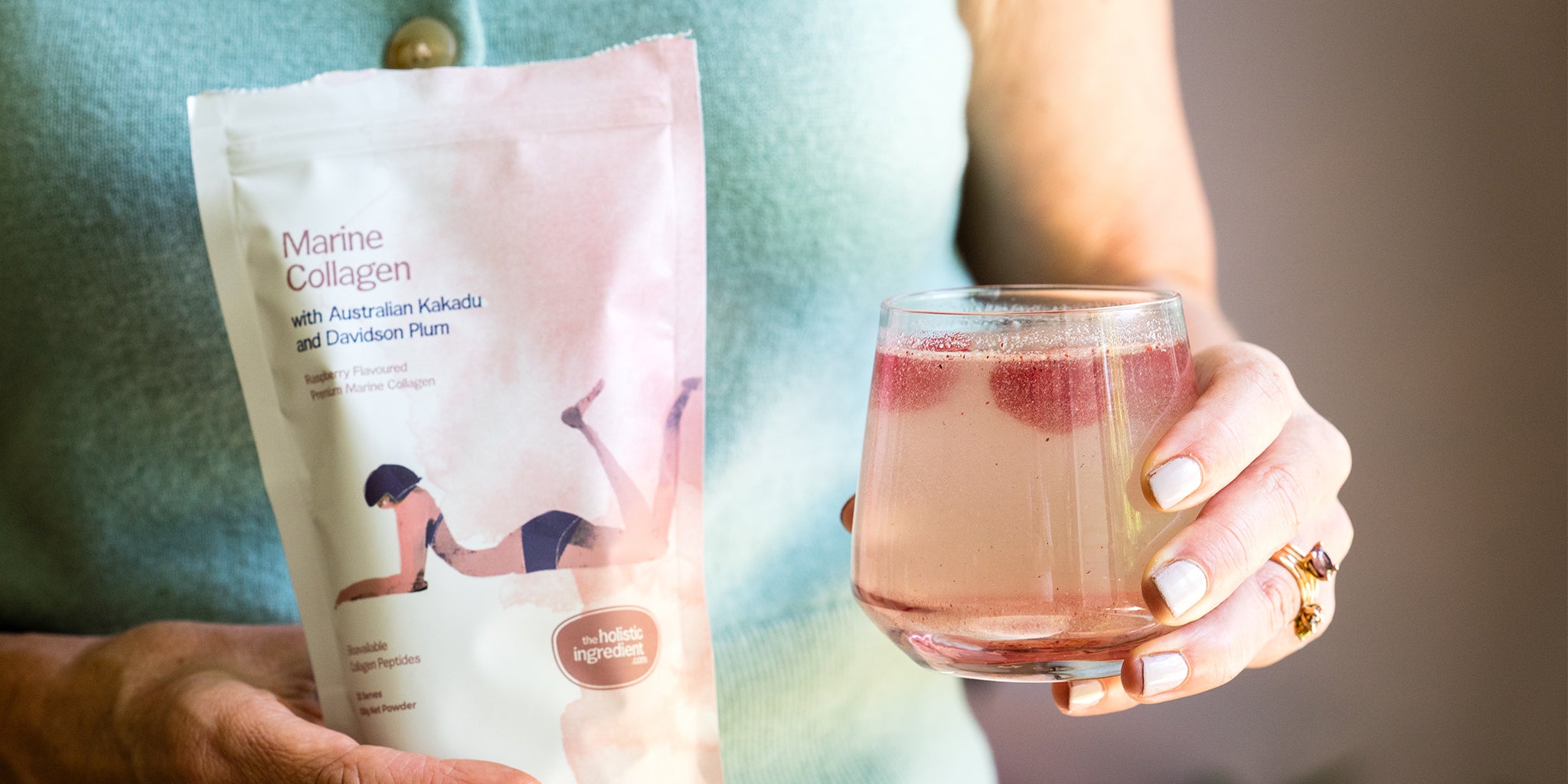 Amy holding a glass of Marine Collagen with Australian Kakadu and Davidson Plum