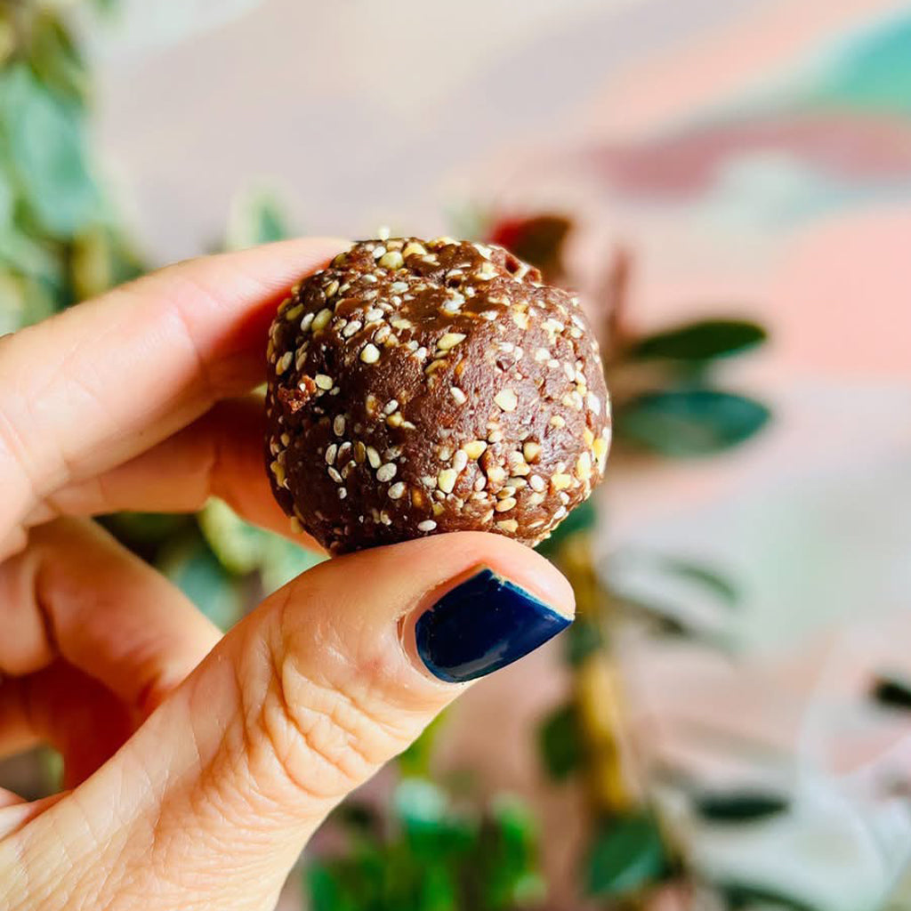 Amy holding a Salted Chocolate Peanut Energy Ball
