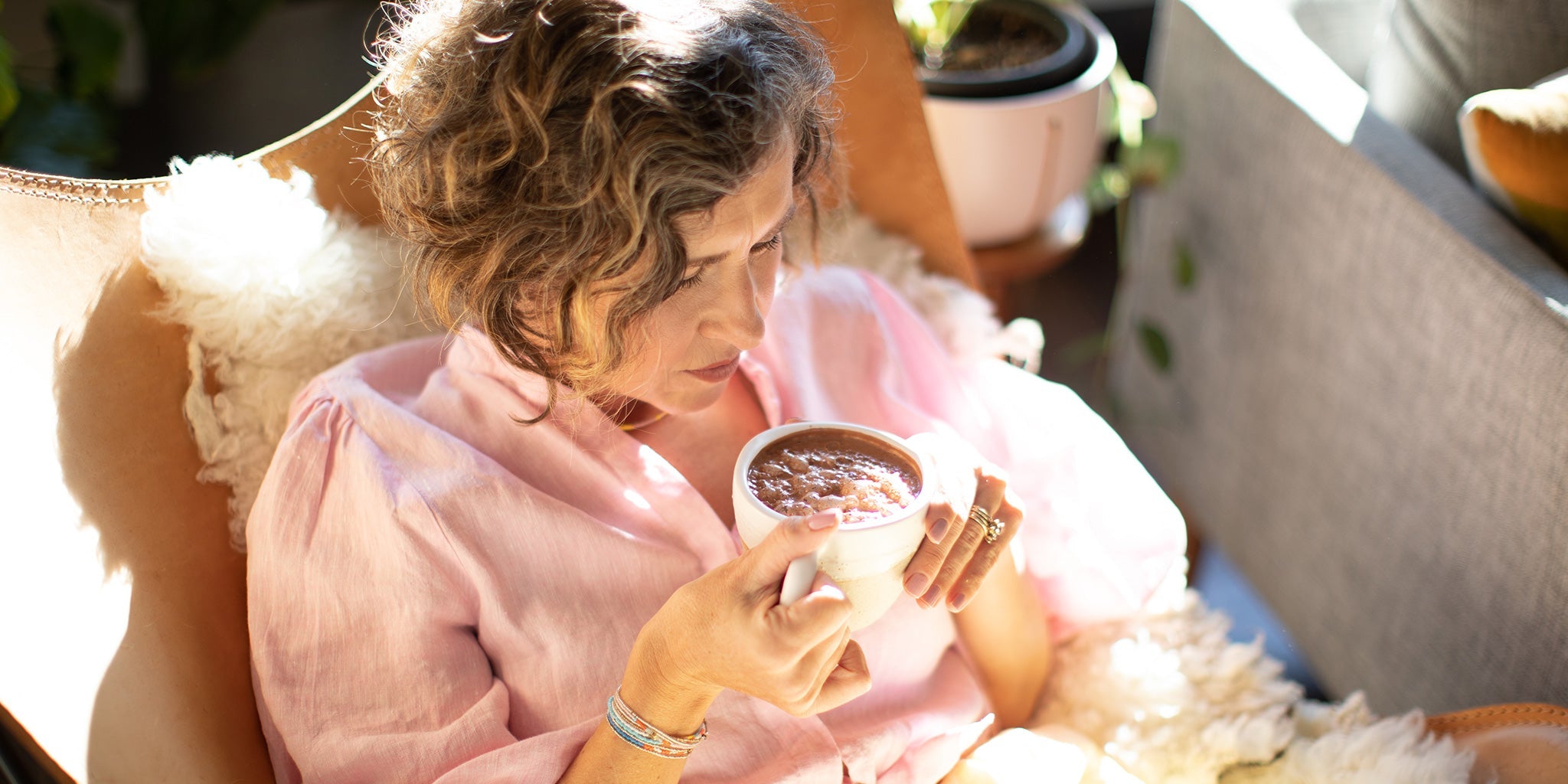 Amy drinking a cup of ceremonial cacao. 