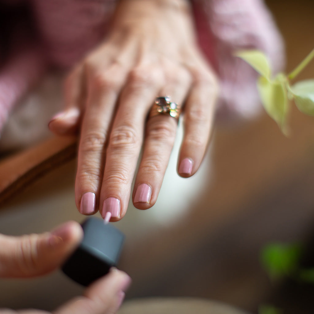 Amy Crawford painting her nails with pink Hanami nail polish