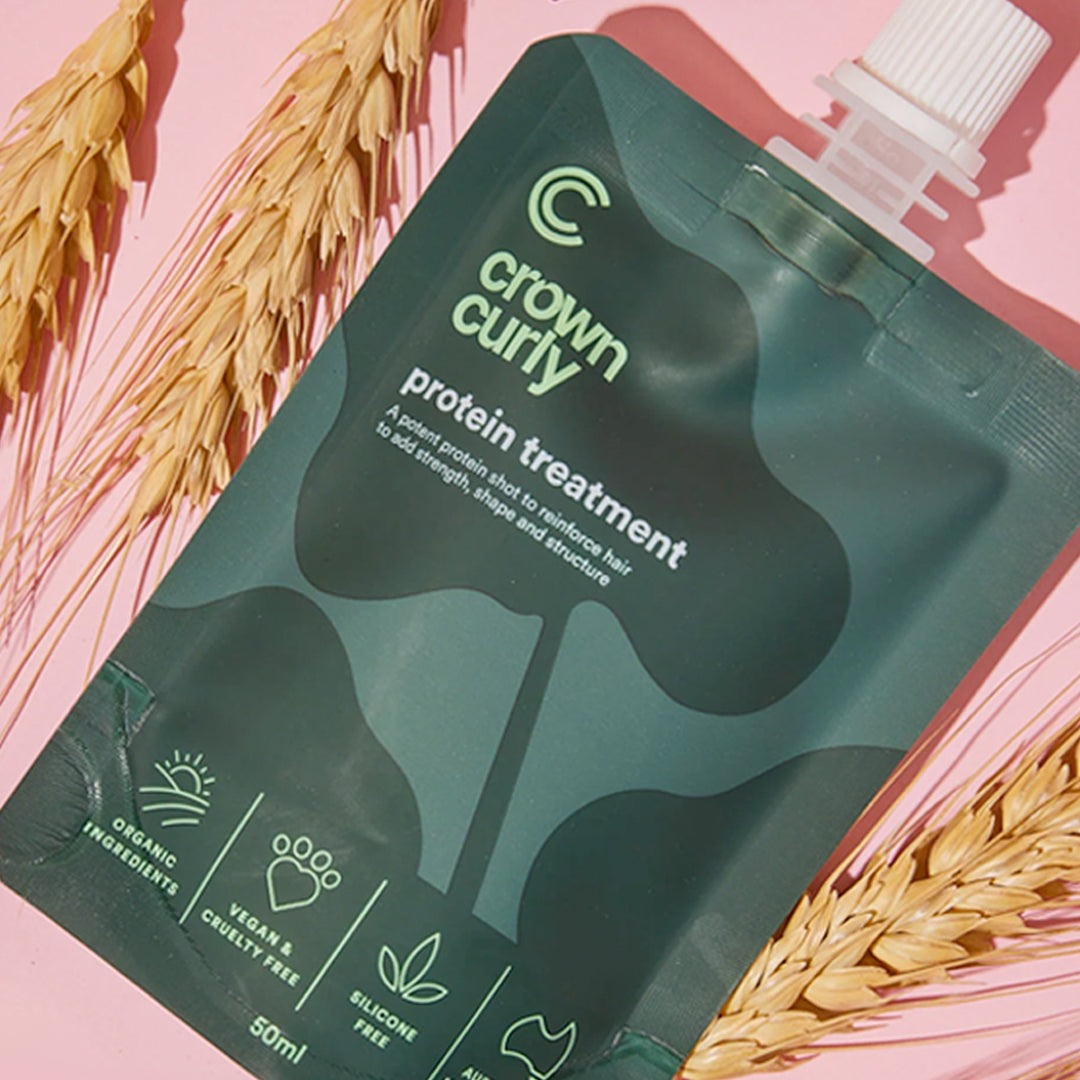Helen tests the strength of Amy's hair to see if she needs Crown Curly's Protein Treatment.